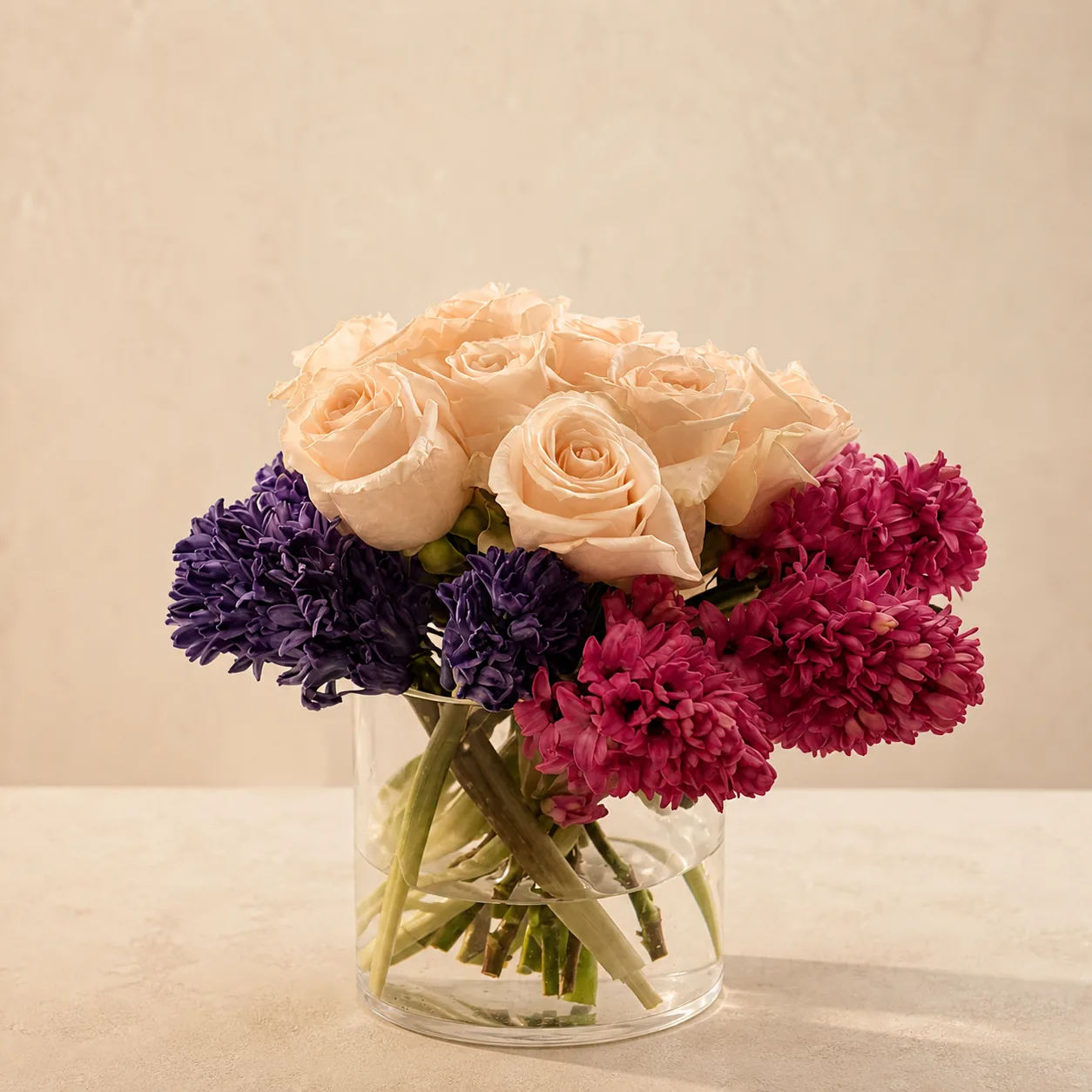 Cream roses with violet and magenta hyacinths