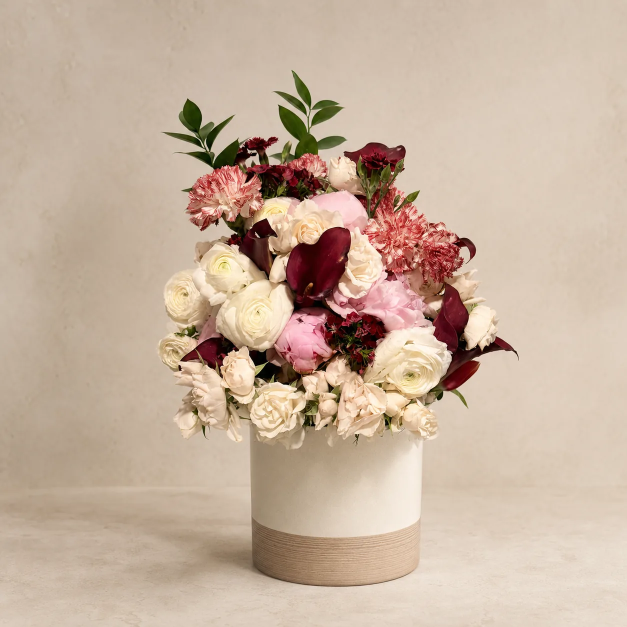 Wine, cream, and blush floral arrangement by Moty Fard