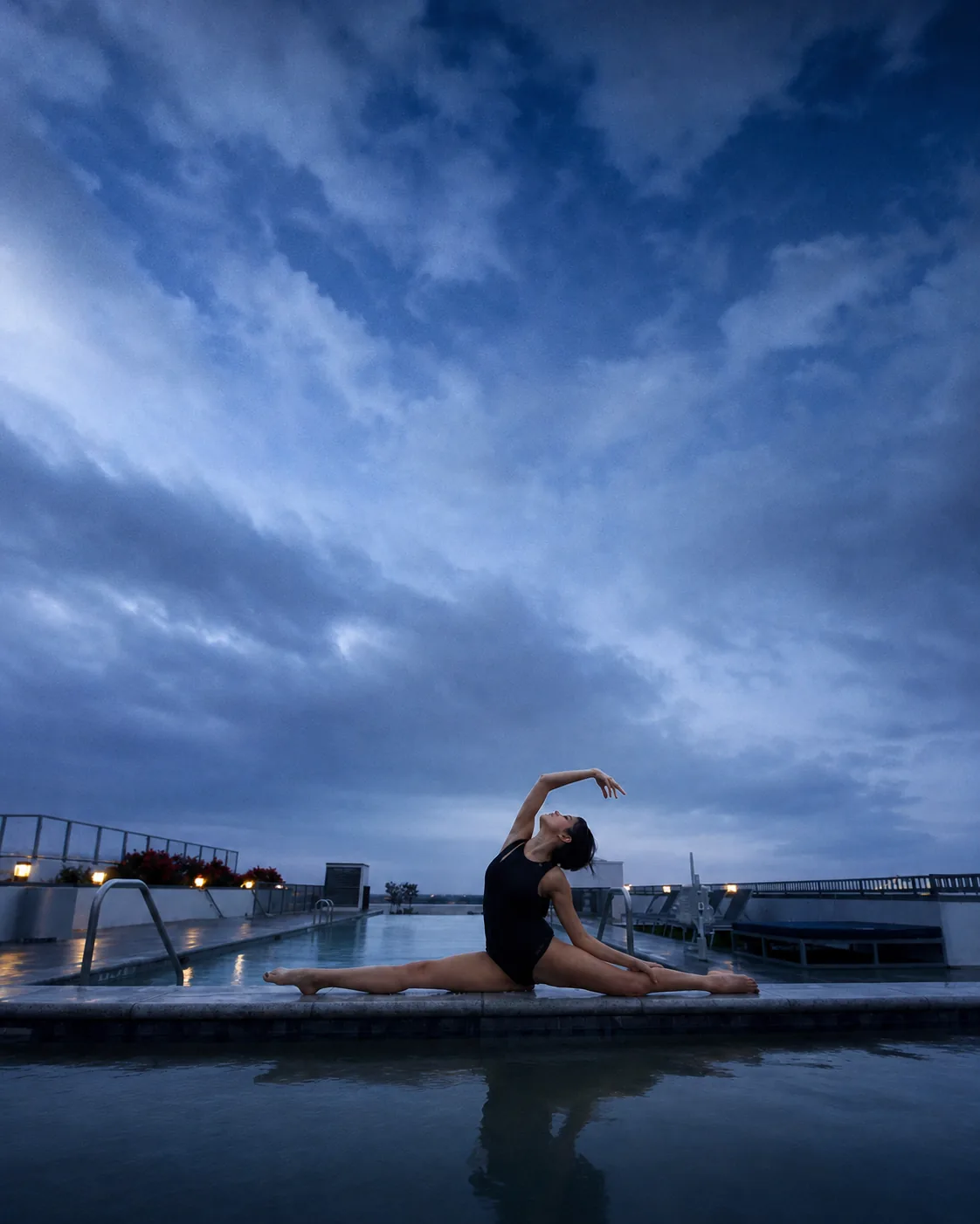 Moty Fard practicing a split beside a pool